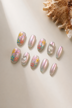 Flat lay of Begin Again iridescent floral press-on nails with colorful blossoms and crystal accents