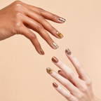 Two hands wearing Golden Hour bronze metallic citrine press-on nails on a peach background