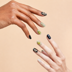 Two hands wearing Green Calm green aventurine press-on nails on a peach background
