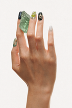 Hand wearing Green Calm green gradient press-on nails with gold foil and aventurine
