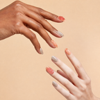 Two hands wearing Stay Soft blush rose quartz press-on nails on a peach background